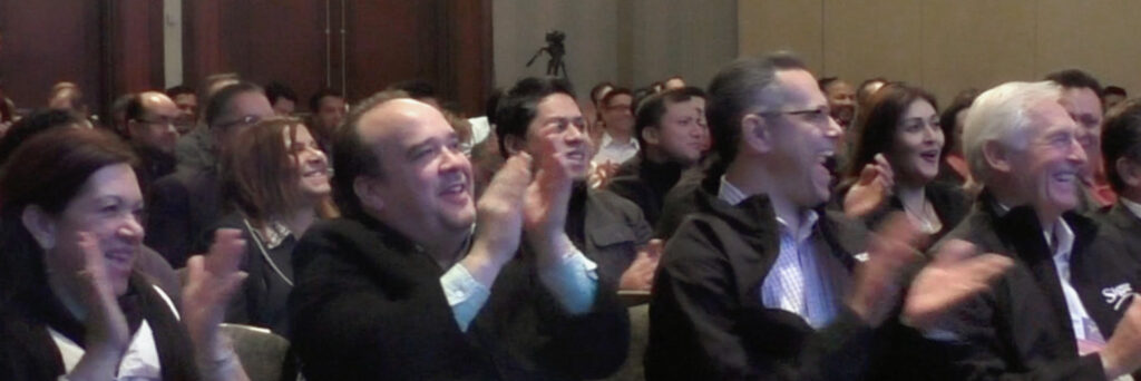 Audience applause at a sales retreat. 